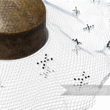 Petershams Millinery Supplies vintage 1930s honeycomb veiling round with black X-shaped embroidery details.