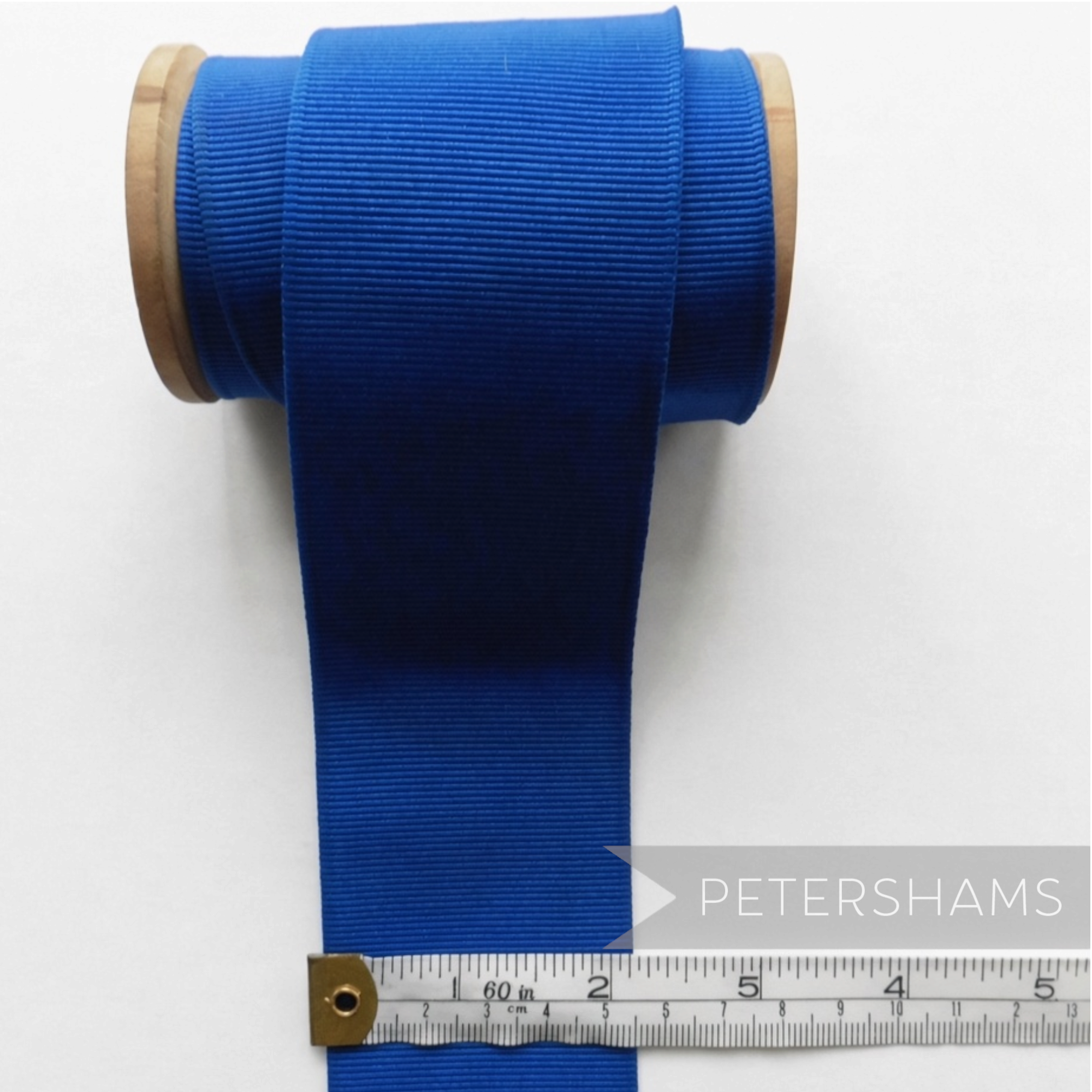 Petershams Millinery Supplies 53mm wide royal blue ribbed belting ribbon on a wooden spool with measuring tape