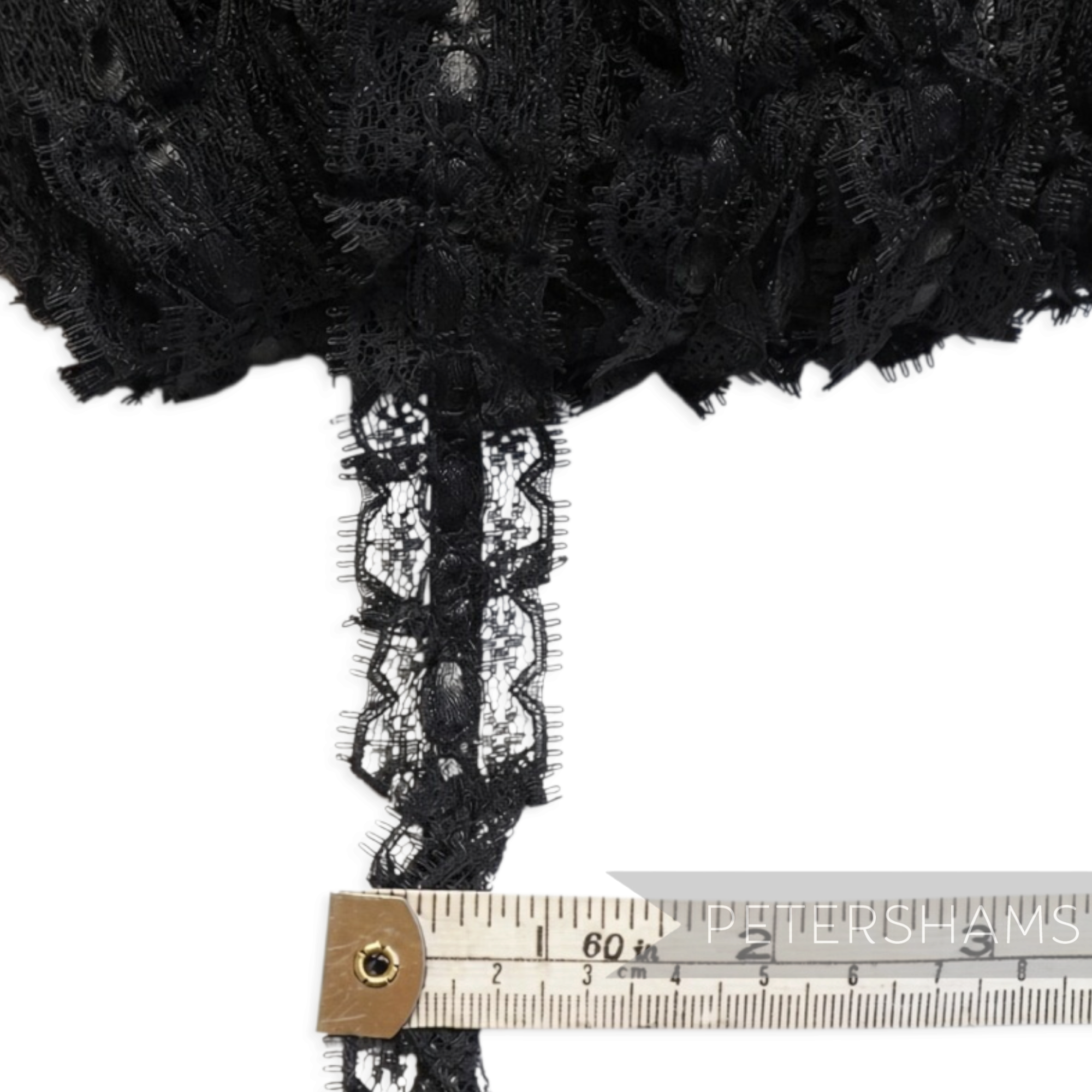 Petershams Millinery Supplies 25mm black frilly lace trim with a satin ribbon centre for sewing and craft projects.
