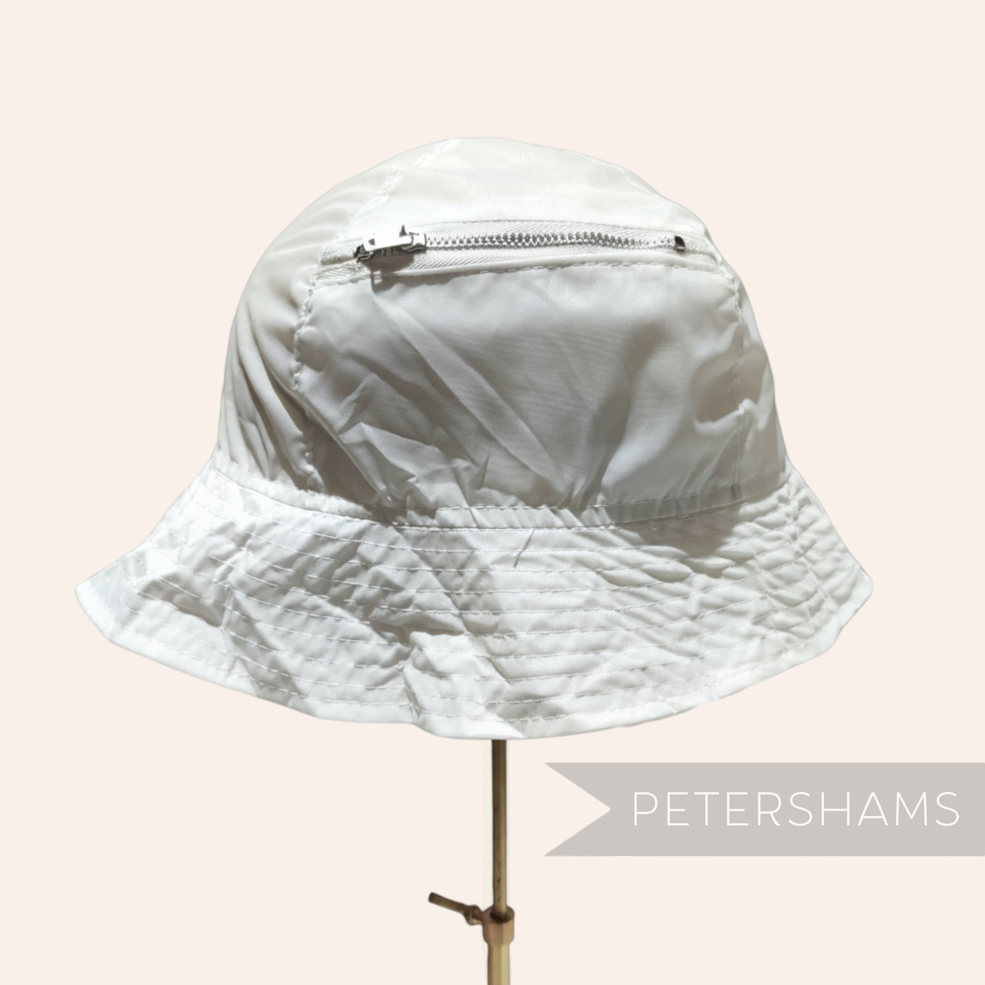 Petershams Millinery Supplies vintage white nylon children's bucket hat with a built-in zippered storage pouch.