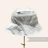 Petershams Millinery Supplies vintage white nylon children's bucket hat with a built-in zippered storage pouch.