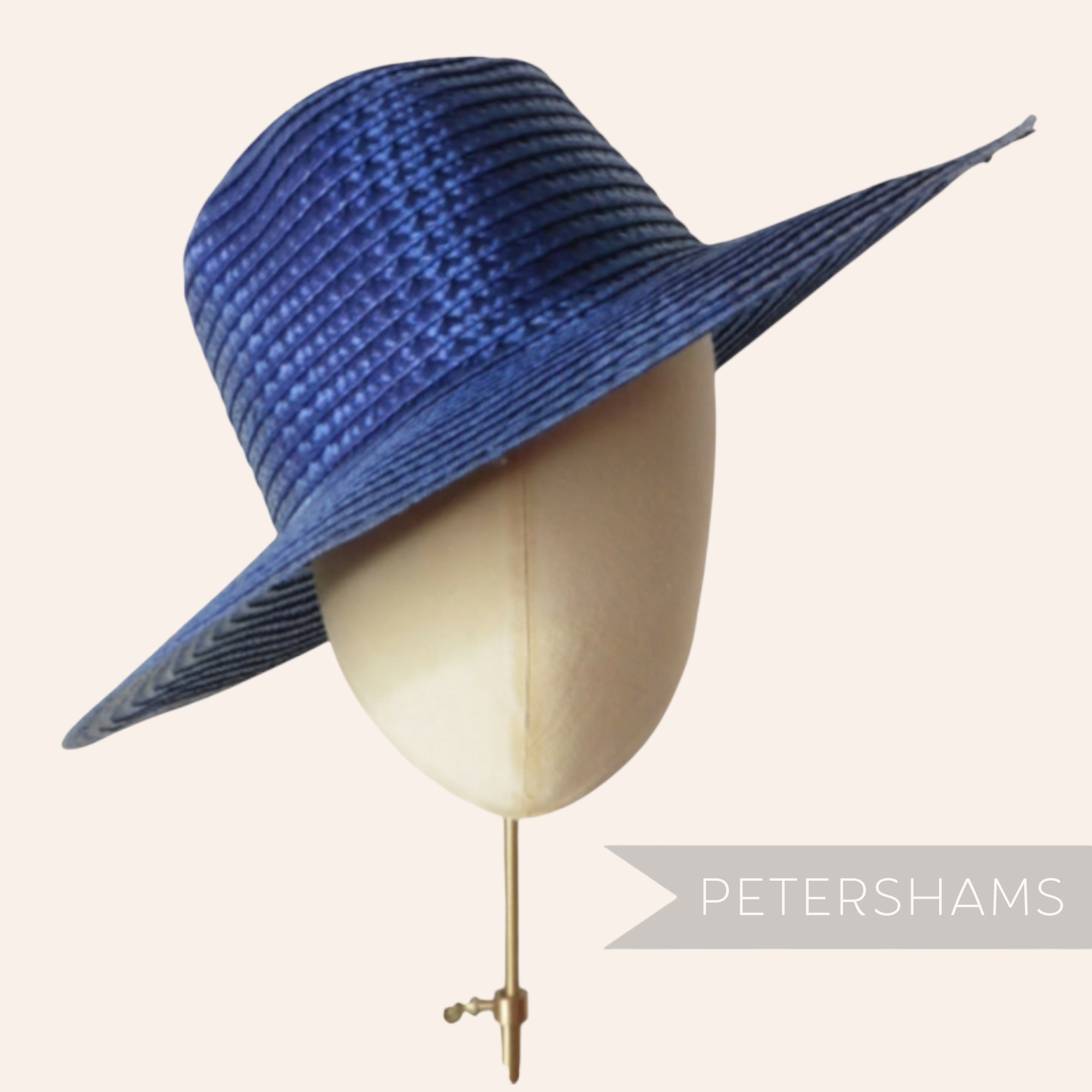 Petershams Millinery Supplies shiny blue flat polybraid capeline hat body on a millinery head form.