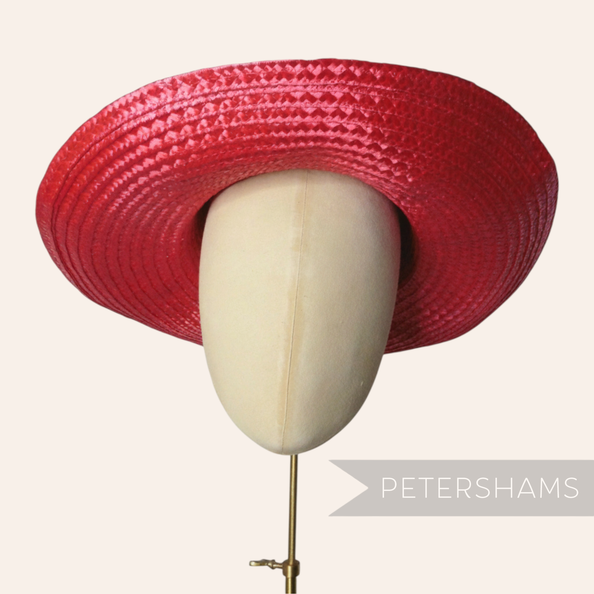 Petershams Millinery Supplies shiny red flat polybraid capeline hat body on a millinery head form.