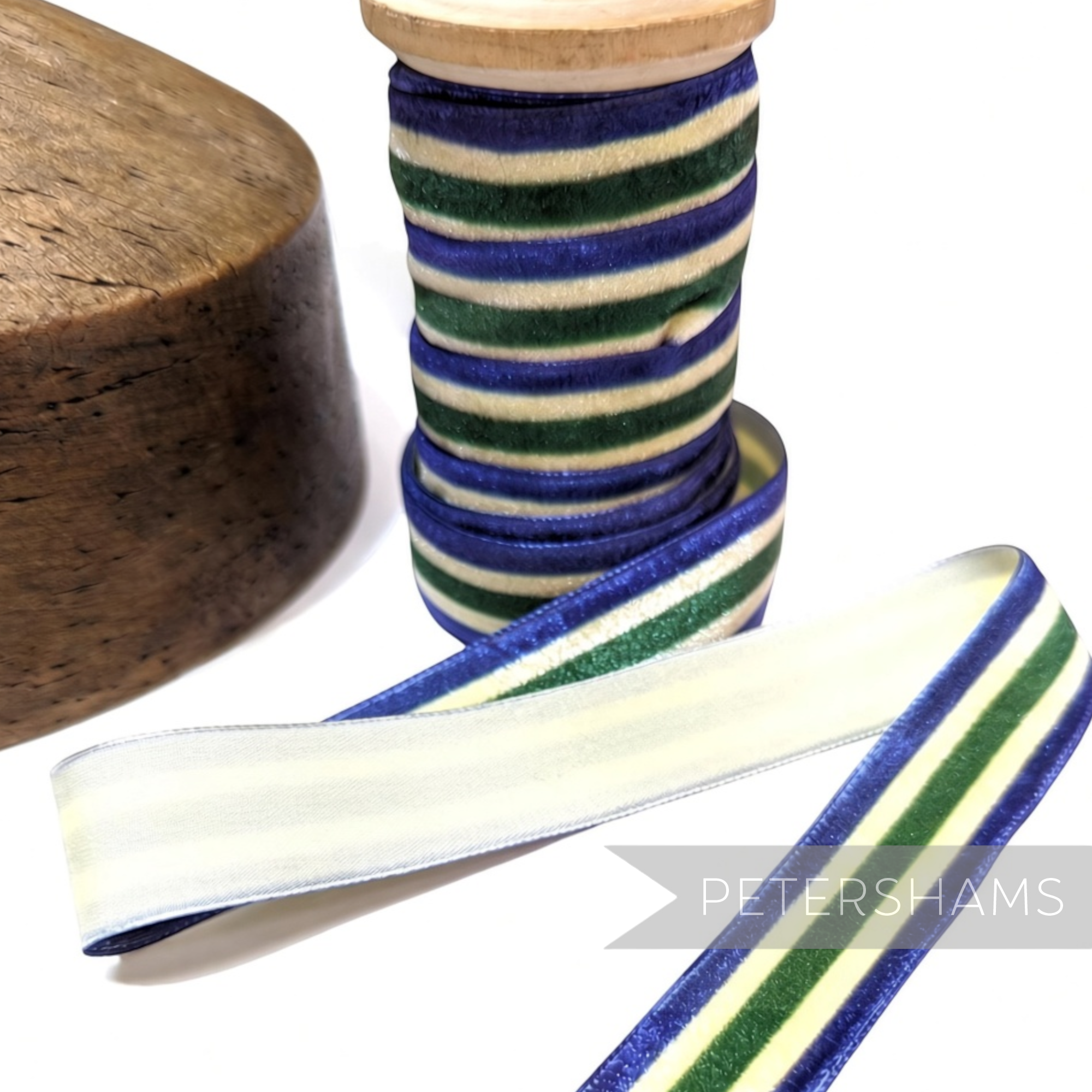 Petershams Millinery Supplies 23mm striped French velvet ribbon in blue, green, and cream on a wooden spool.