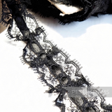 Petershams Millinery Supplies 25mm black frilly lace trim with a central satin ribbon detail