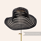 Petershams Millinery Supplies black swirled crinoline and shiny polybraid capeline hat body with upturned brim.