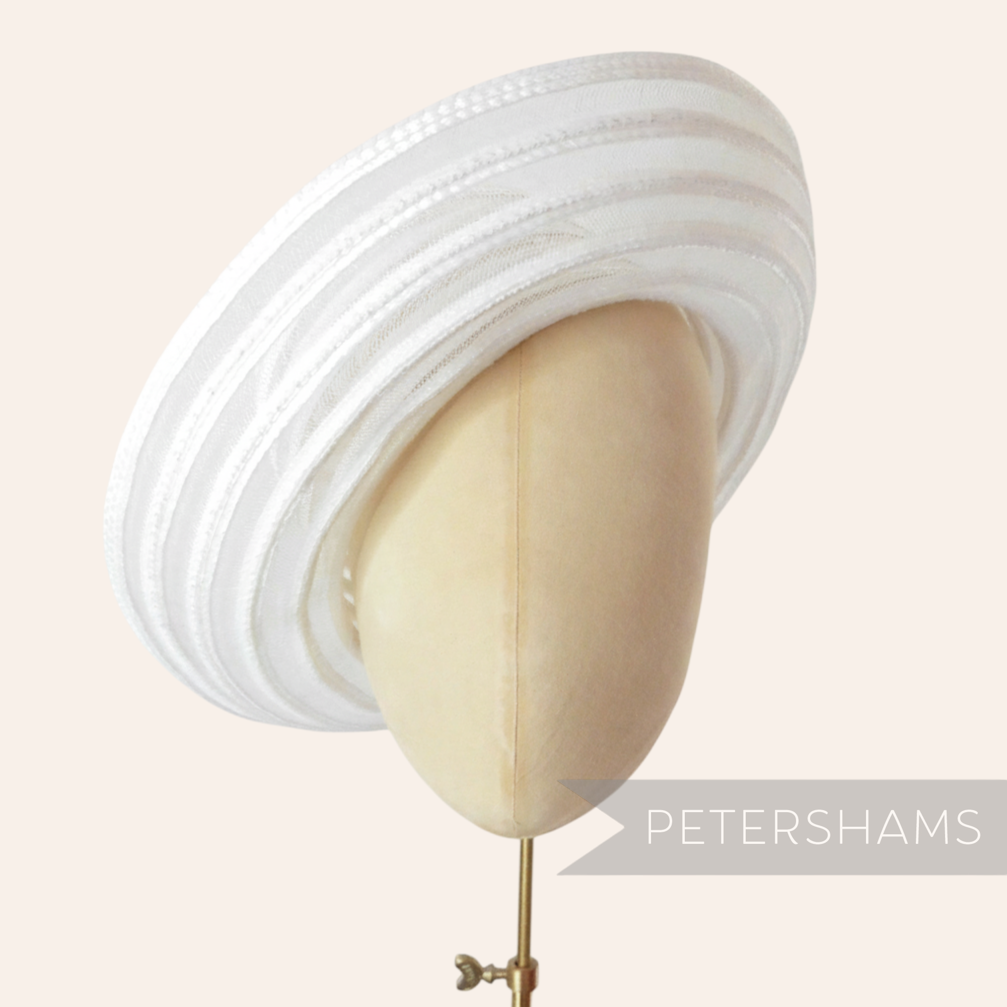 Petershams Millinery Supplies white swirled crinoline and shiny polybraid capeline hat body on a mannequin head