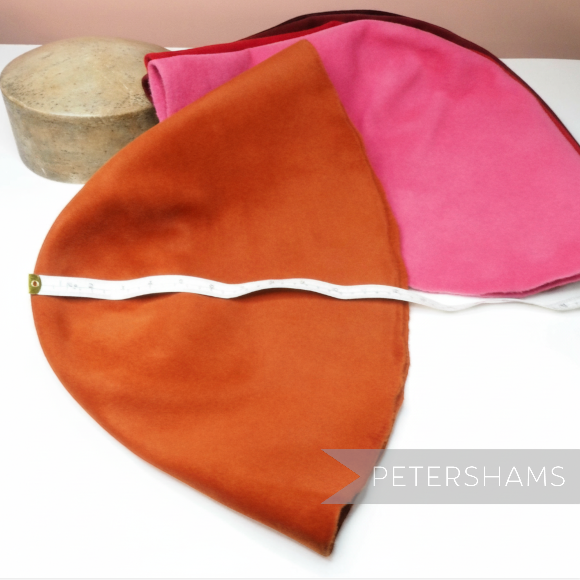 Petershams Millinery Supplies extra large double faced peachbloom fur felt hat cones in orange and pink with tape measure