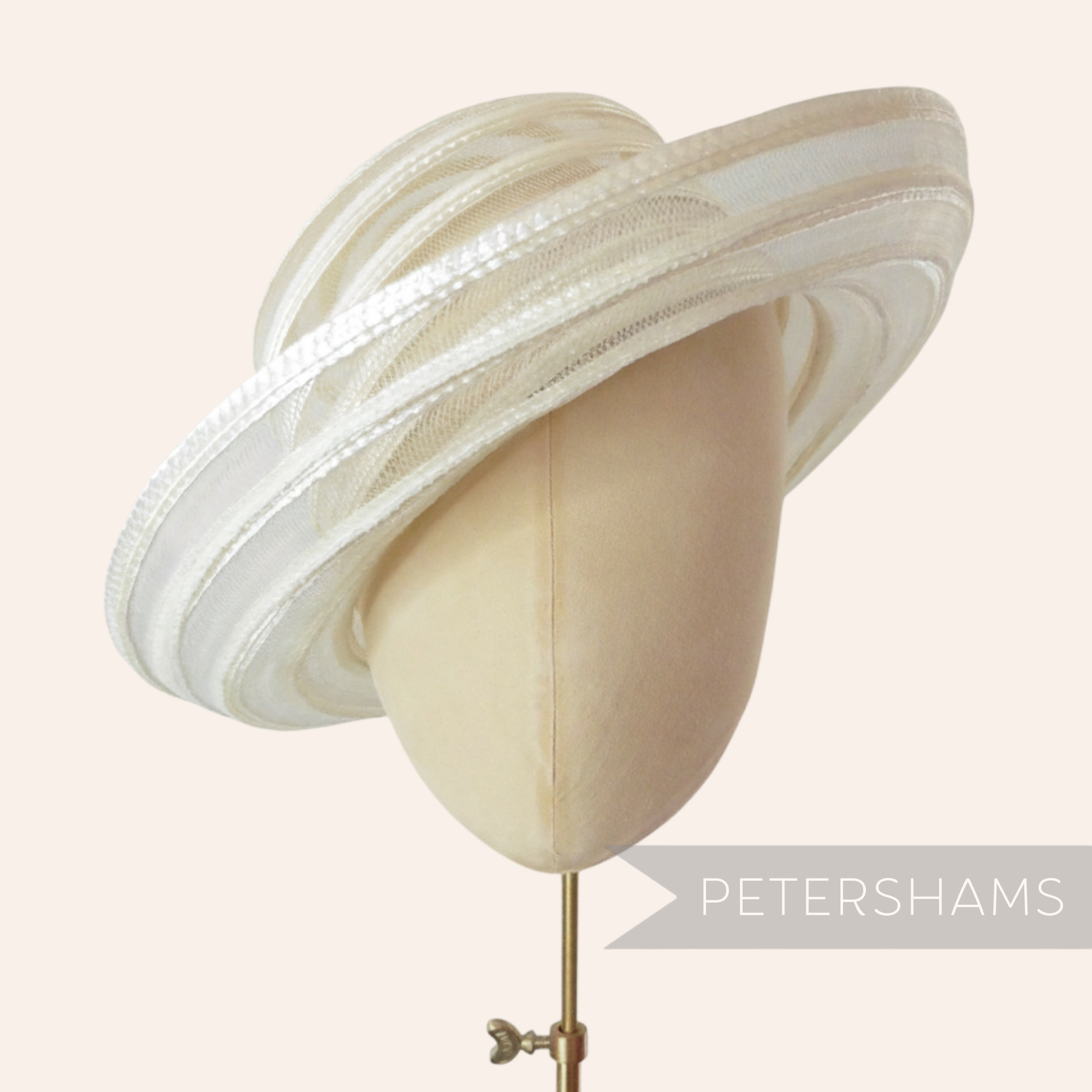 Petershams Millinery Supplies white swirled crin and shiny polybraid capeline hat body on a mannequin head