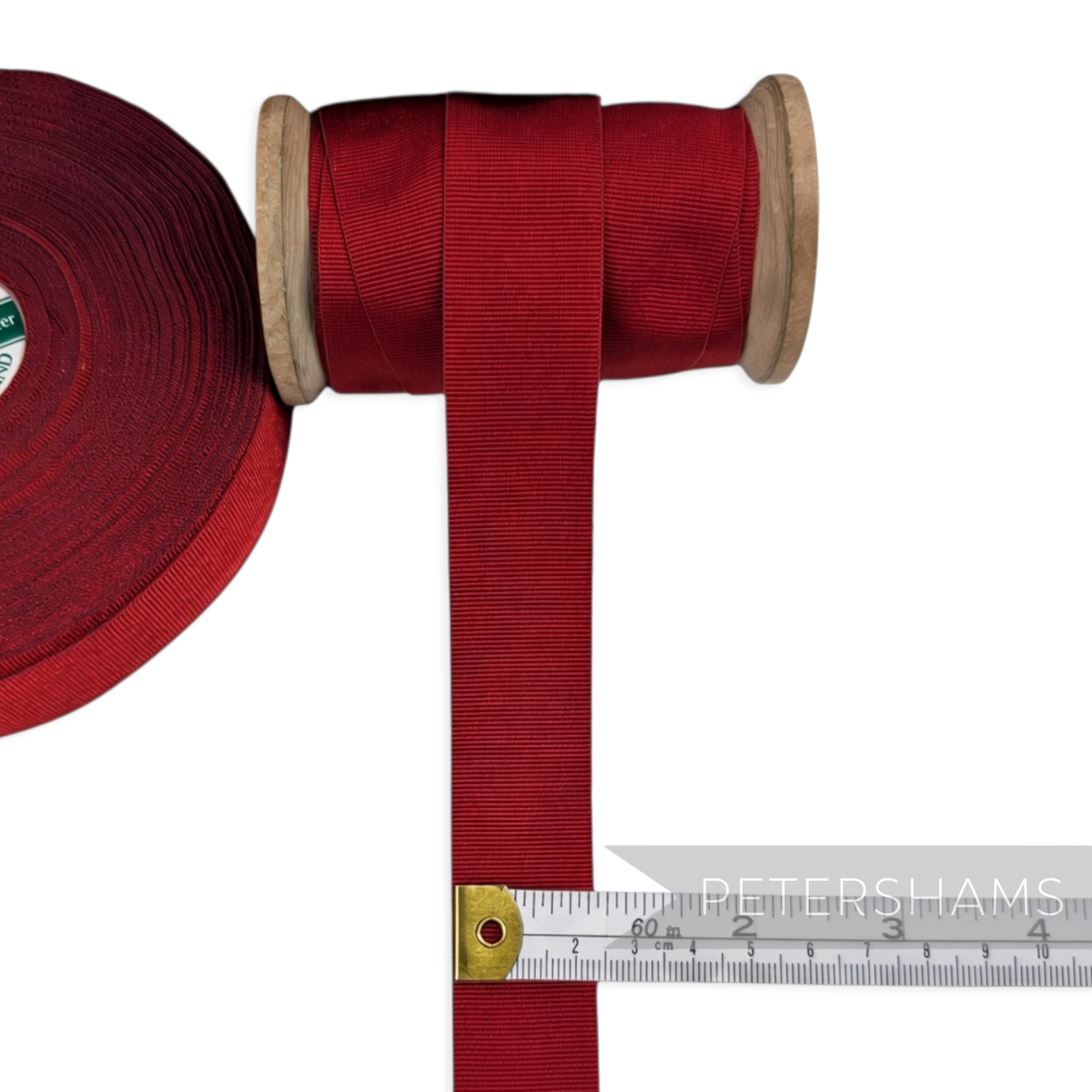 Petershams Millinery Supplies 25mm wide vintage red grosgrain ribbon on a wooden spool with a measuring tape