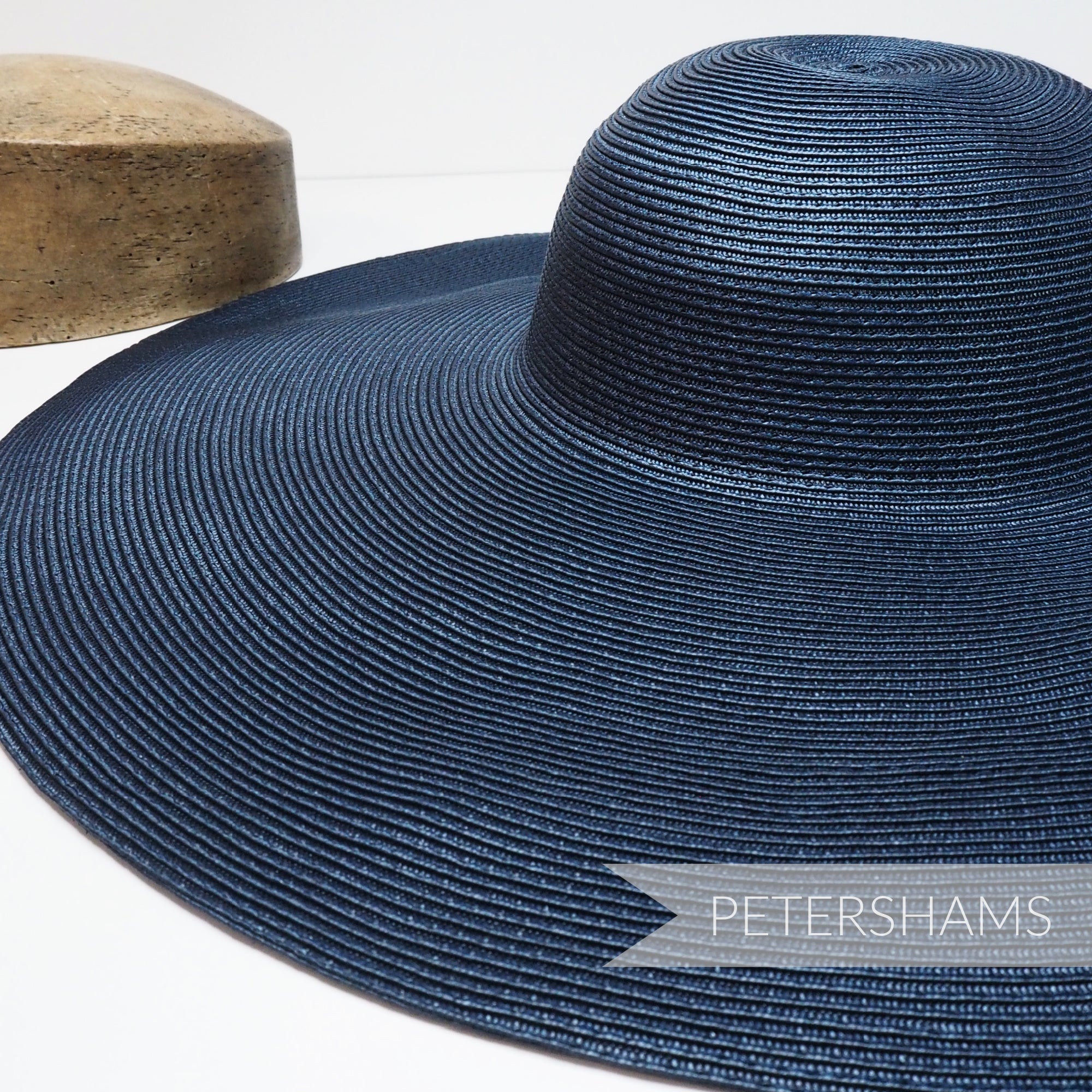 Petershams Millinery Supplies XL navy blue polybraid capeline hat body with a smooth satin finish and wide brim.