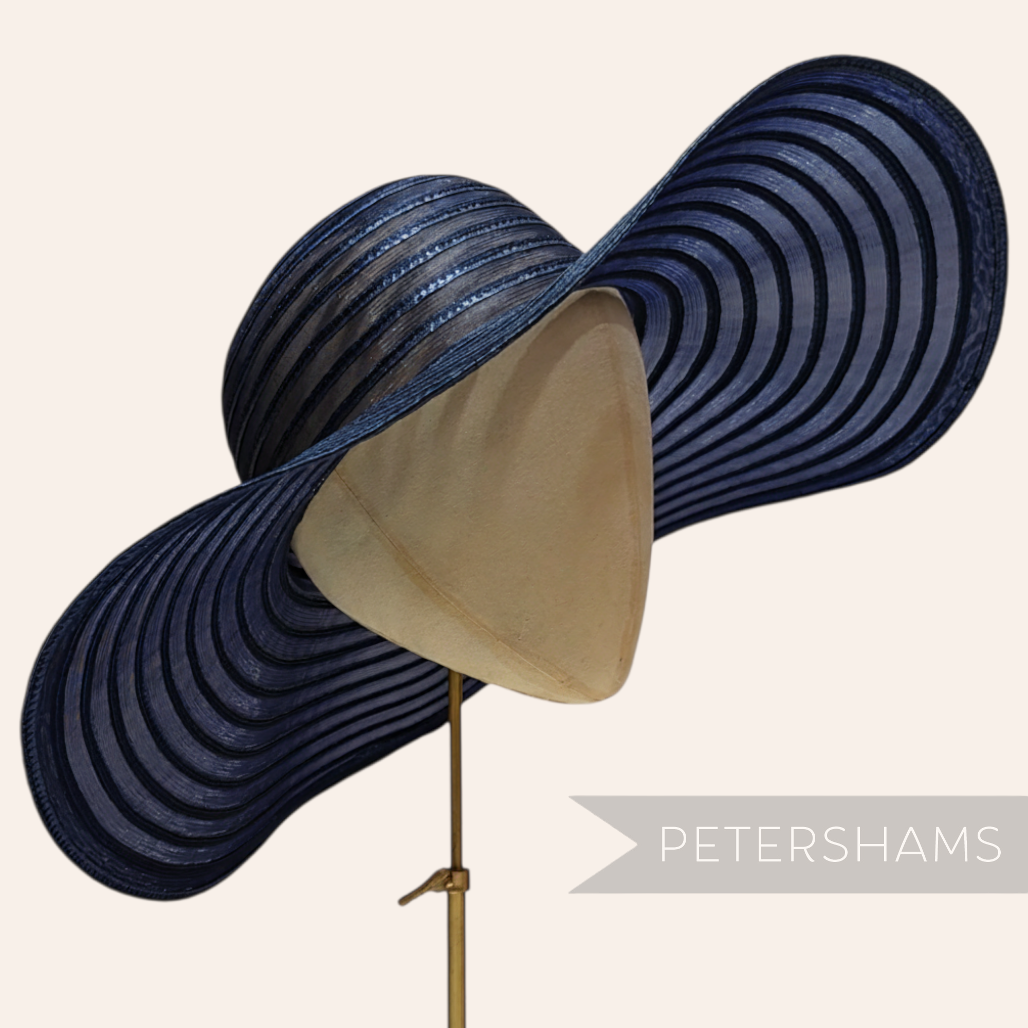 Petershams Millinery Supplies navy blue striped polybraid crin capeline hat body on a millinery head block