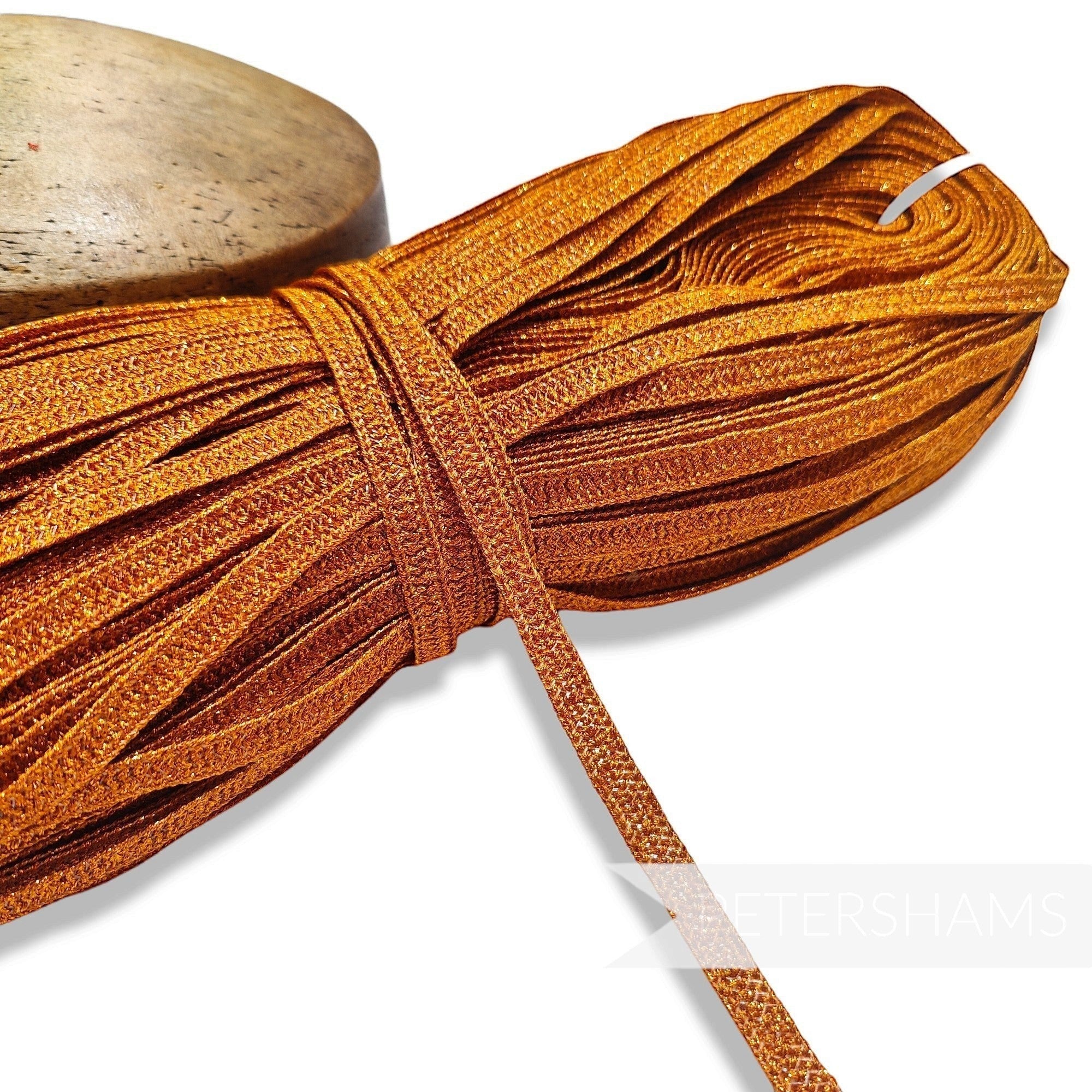 Petershams Millinery Supplies 10mm metallic copper lurex hat braid in a full 80m hank with a raised zig-zag texture.