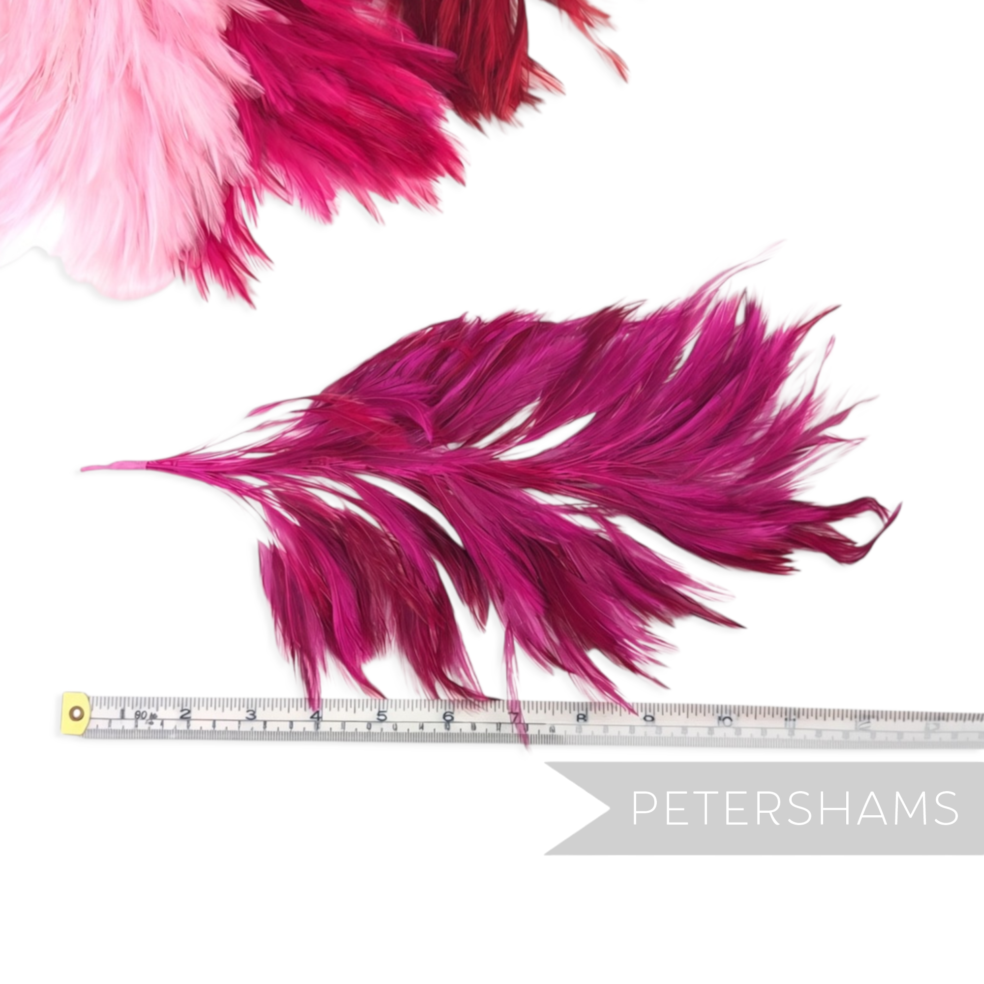 Petershams Millinery Supplies large magenta stripped hackle feather mount on a wired stem with measuring tape