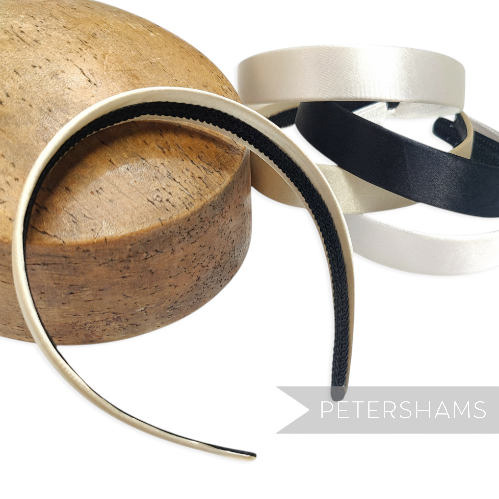 Petershams Millinery Supplies 24mm wide satin covered plastic headbands in black and cream, ideal for fascinators.