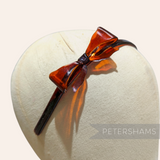 Petershams Millinery Supplies vintage amber plastic headband with a 6cm bow, 8mm band, best for children.