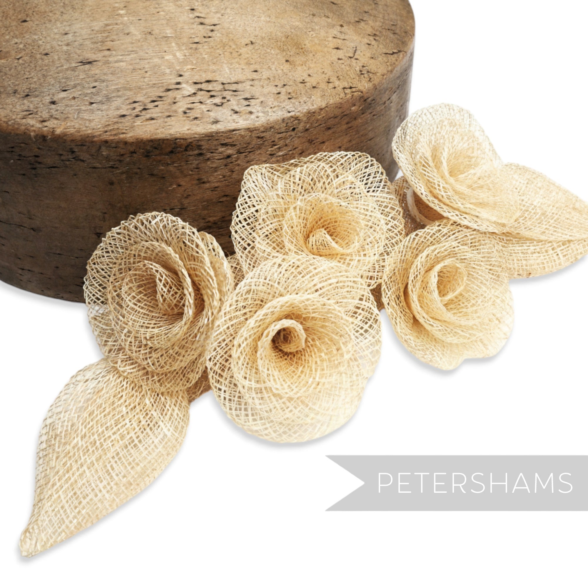 Petershams Millinery Supplies beige sinamay flower and leaf hat mount. Five flowers and two leaves.