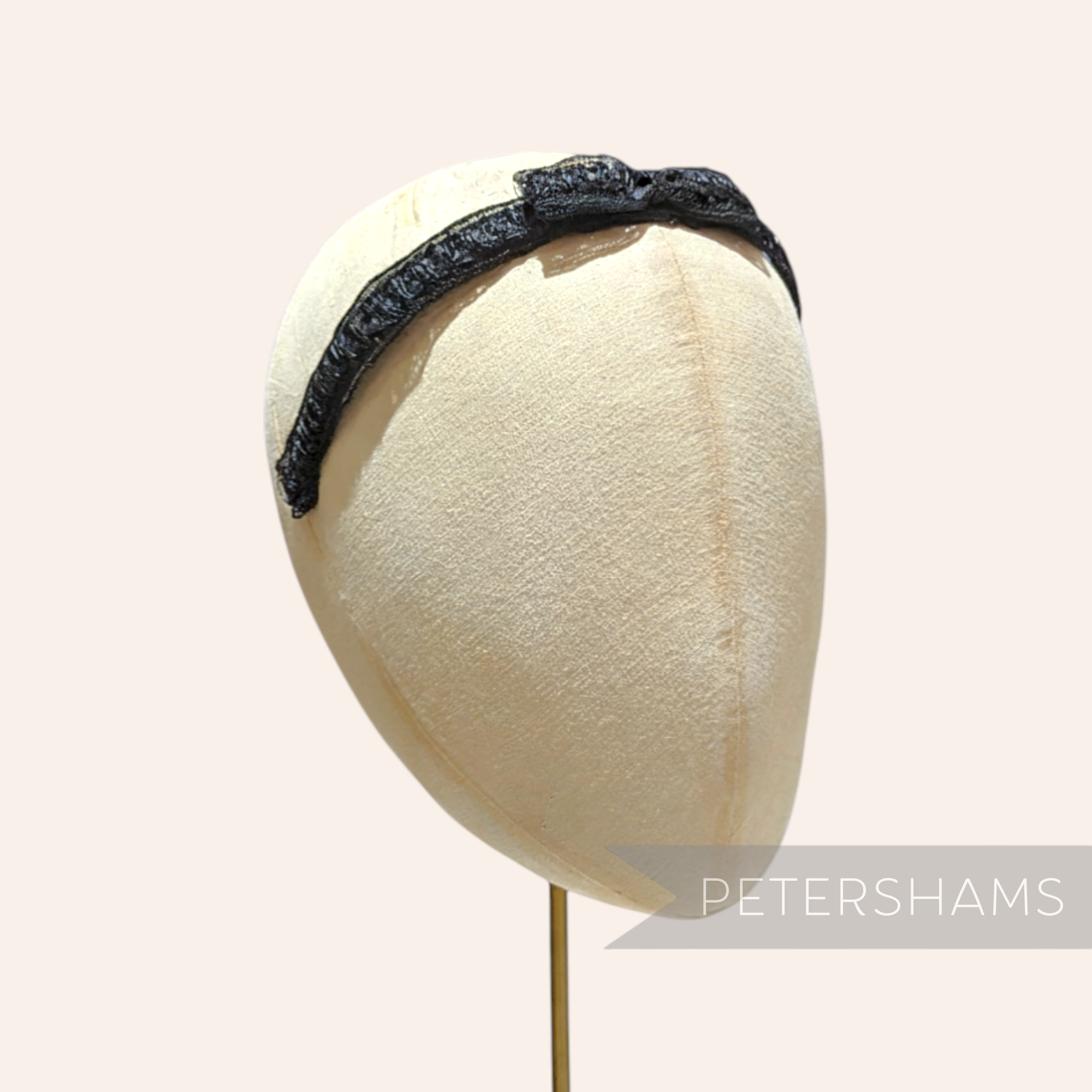 Petershams black laminated raffia and crin braid headband with a small bow, 1960s style.