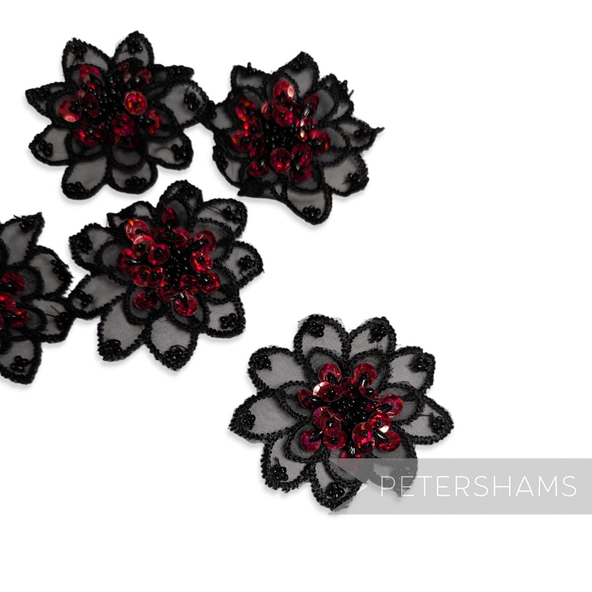Set of five black organza flower motifs with red sequin and beaded centers for bridal millinery and headpieces.