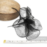 Petershams Millinery Supplies black sinamay flower mount, 20cm wide, with frilly petals and a single leaf on a wired stem.