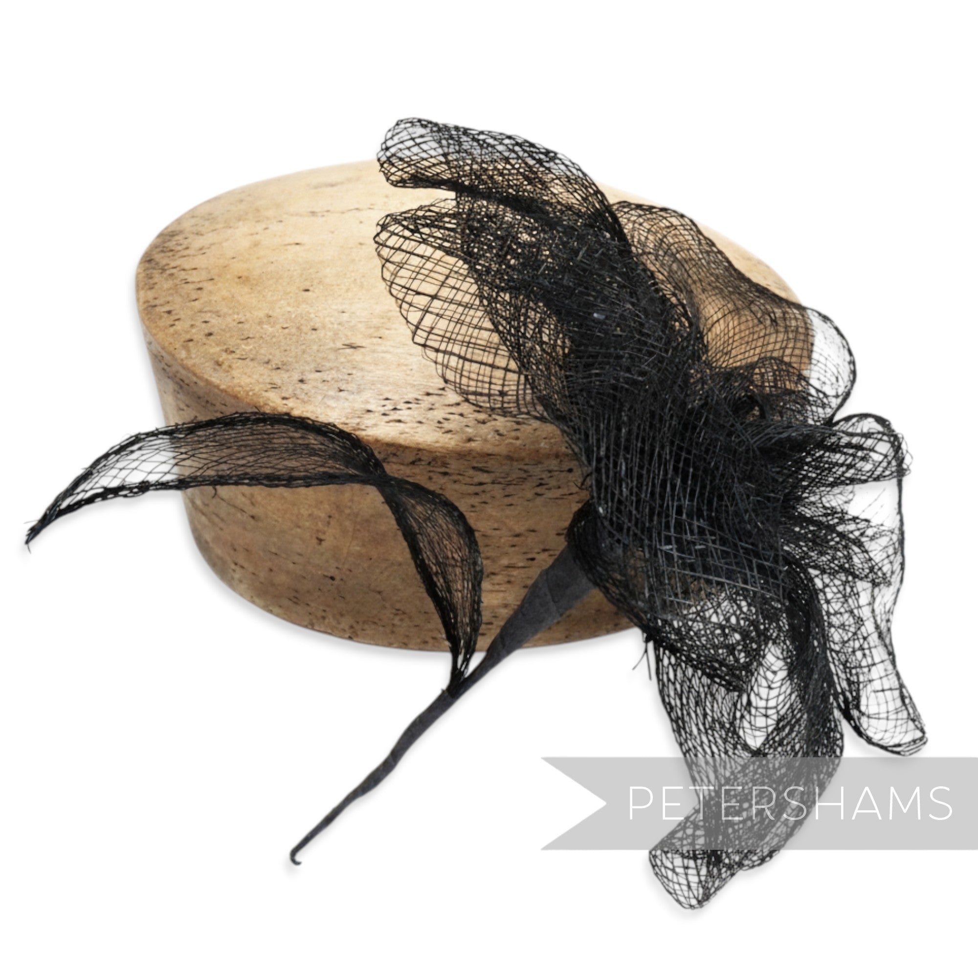 Petershams Millinery Supplies black sinamay flower mount with frilly petals and leaf, 20cm width.