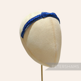 Petershams blue laminated raffia and crin braid headband with a small bow detail, 1960s style.