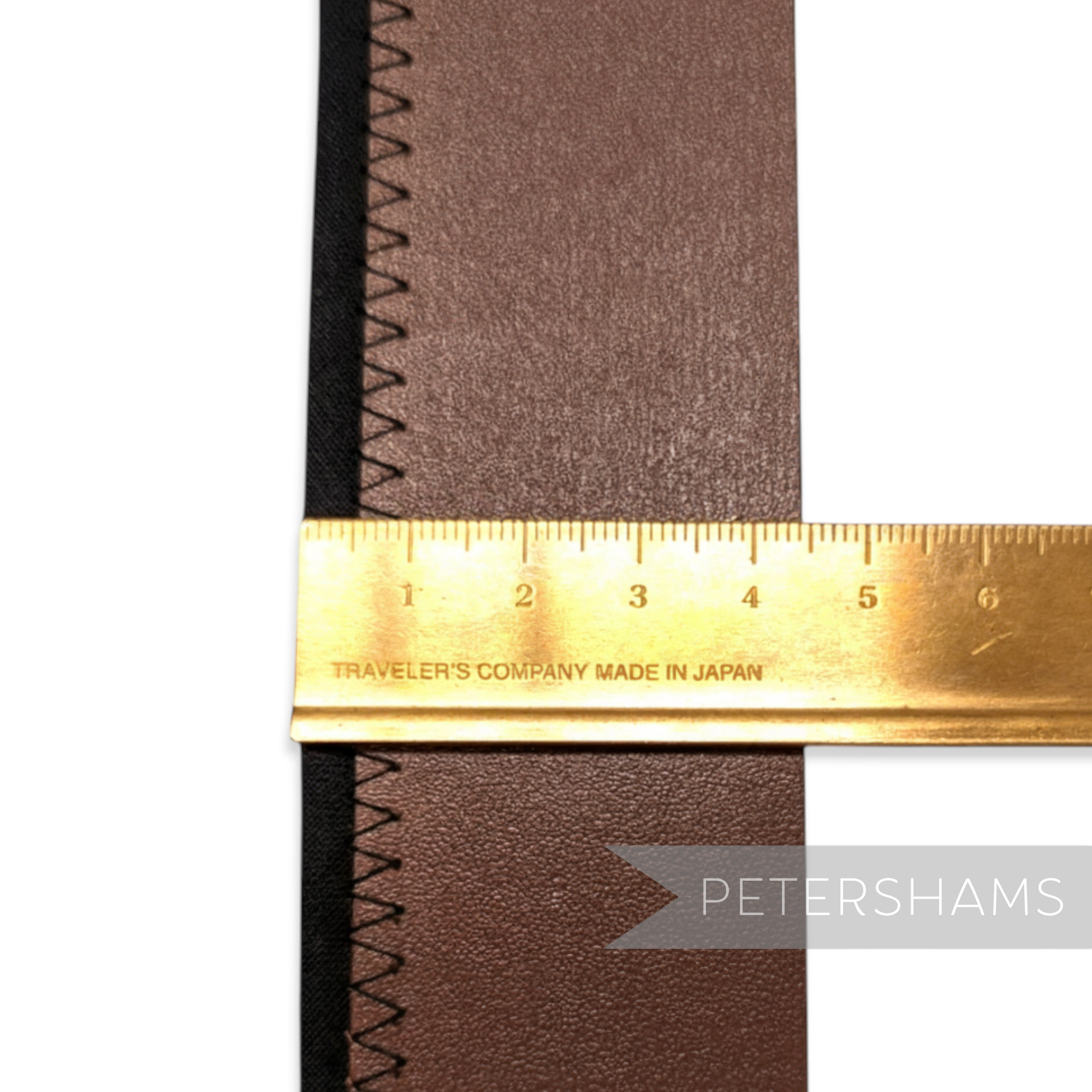 Petershams Millinery Supplies brown bonded leather hat band with black stitching and a ruler measuring width.