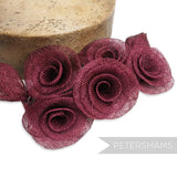 Petershams Millinery Supplies burgundy sinamay flower and leaf hat mount. Five rose-shaped flowers with a flat backing.