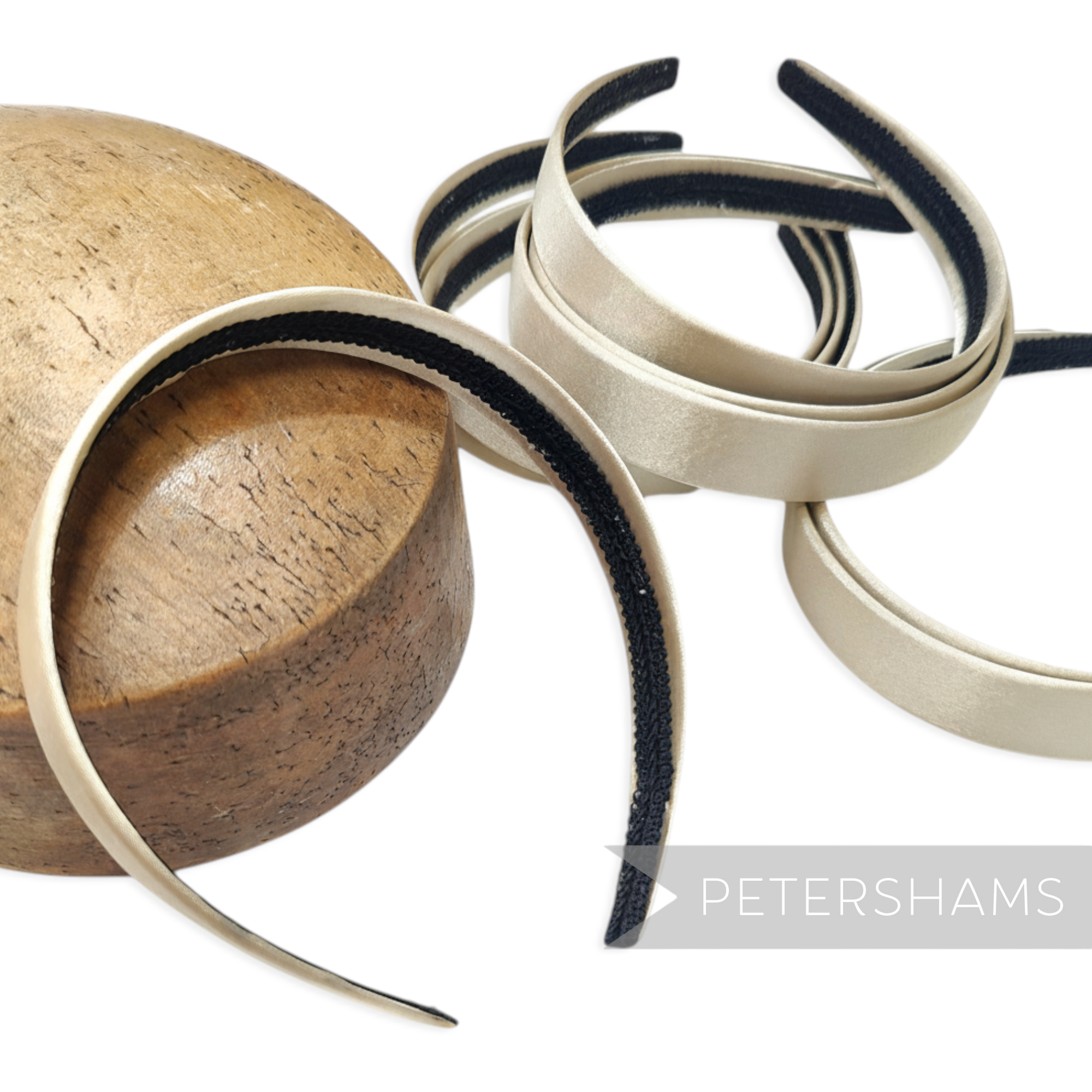 Petershams Millinery Supplies champagne satin covered plastic headbands with black velvet grip, 24mm wide.
