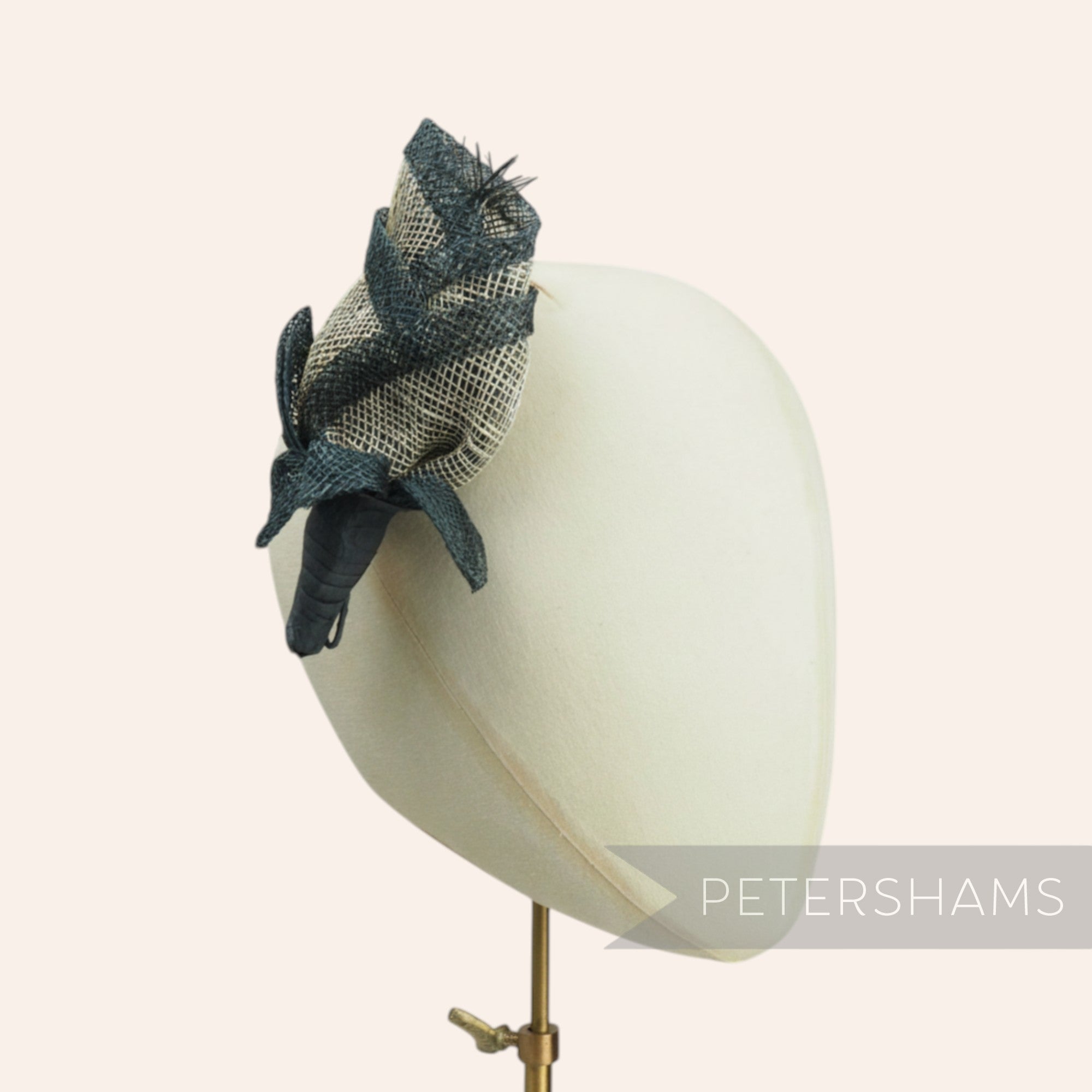 Petershams Millinery Supplies Clara rosebud sinamay flower with dark blue trim and straw stamens on a wired stem.