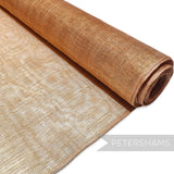 Petershams Millinery Supplies copper sinamay fabric threaded with gold lurex for hat making.