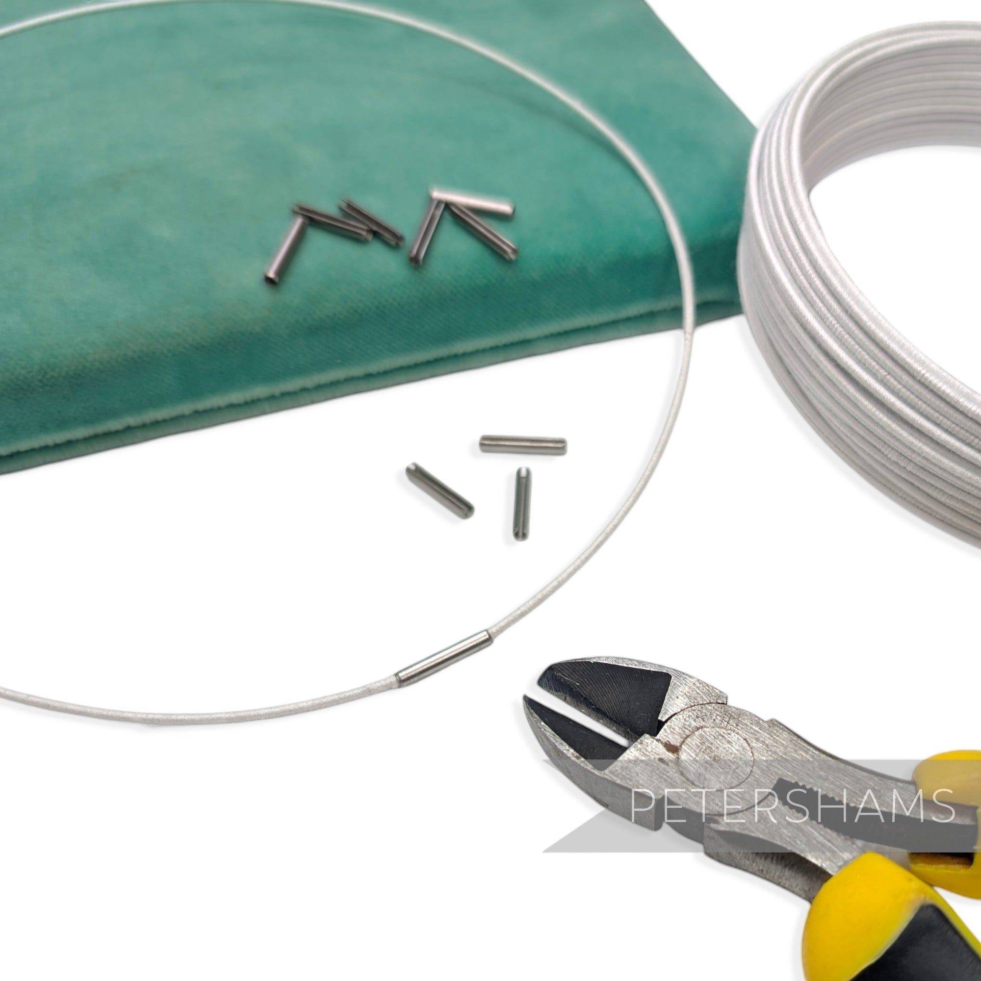 Petershams dark silver wire joining ferrules for millinery hat wire, shown with wire and cutters.