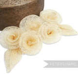 Petershams Millinery Supplies 'Florence' sinamay hat mount with five cream flowers and two leaves. Made from sinamay abaca fabric.