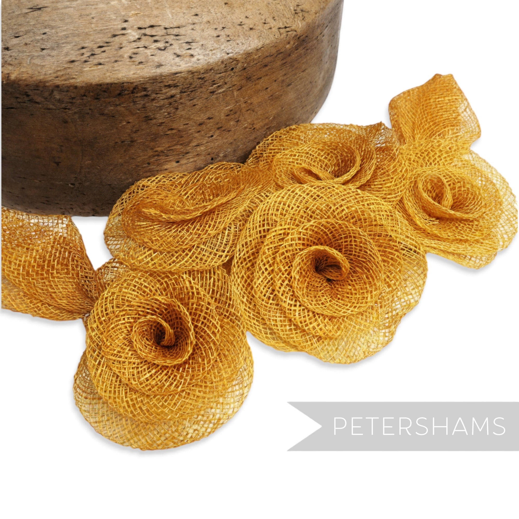 Petershams Millinery Supplies gold sinamay flower and leaf hat mount, 20cm wide.