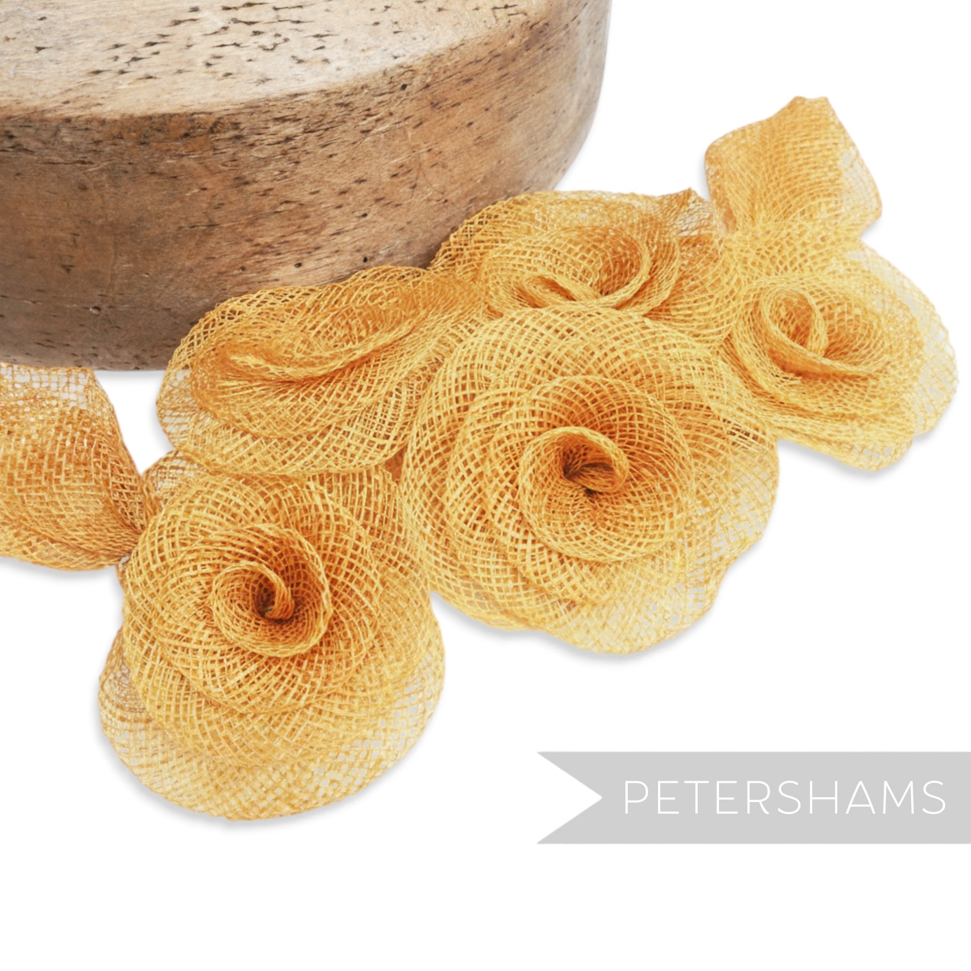 Petershams Millinery Supplies gold sinamay flower and leaf hat mount. Made from sinamay abaca fabric with a flat backing.