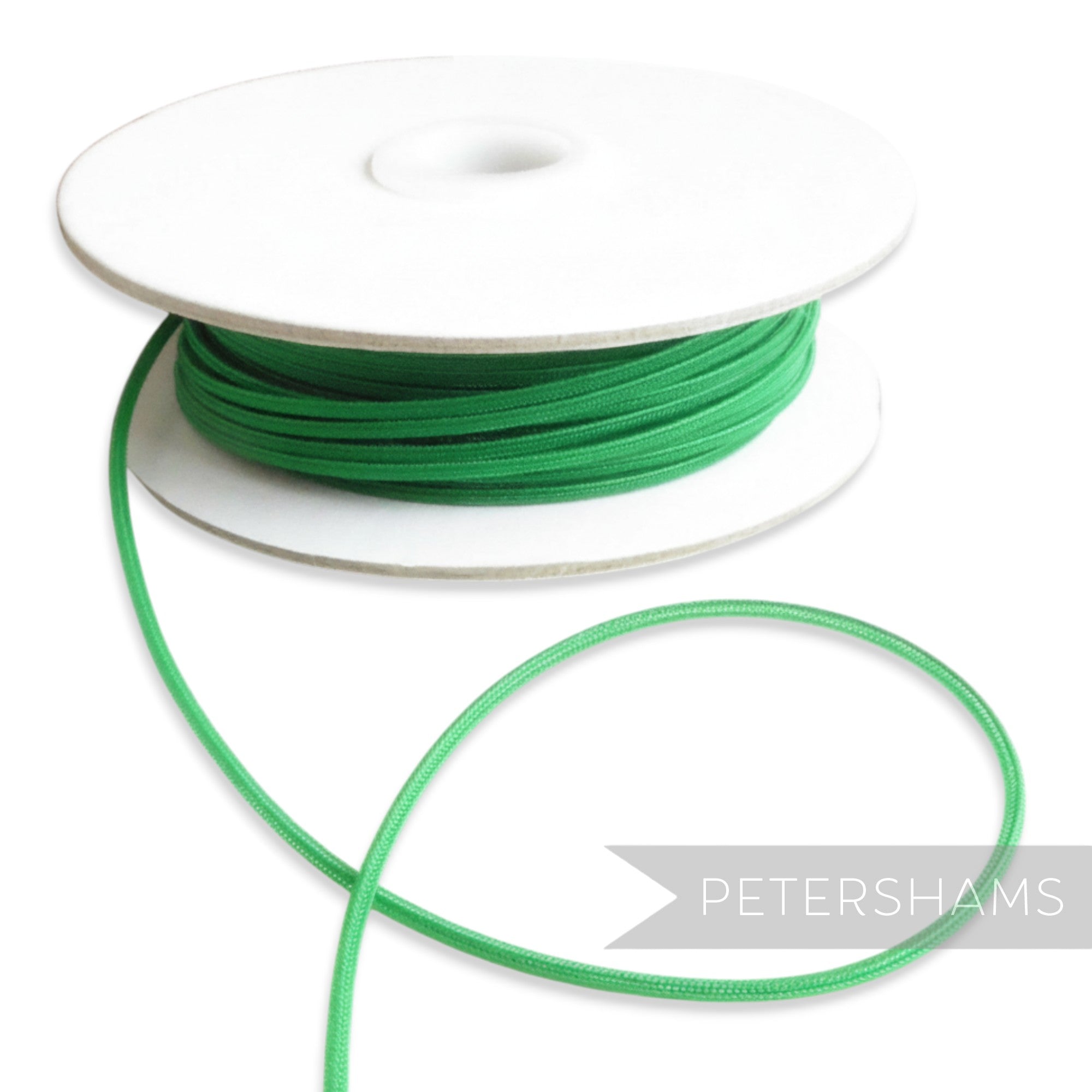 Petershams green 2.5mm tubular millinery crin on a spool, ideal for headbands and graphic shapes.