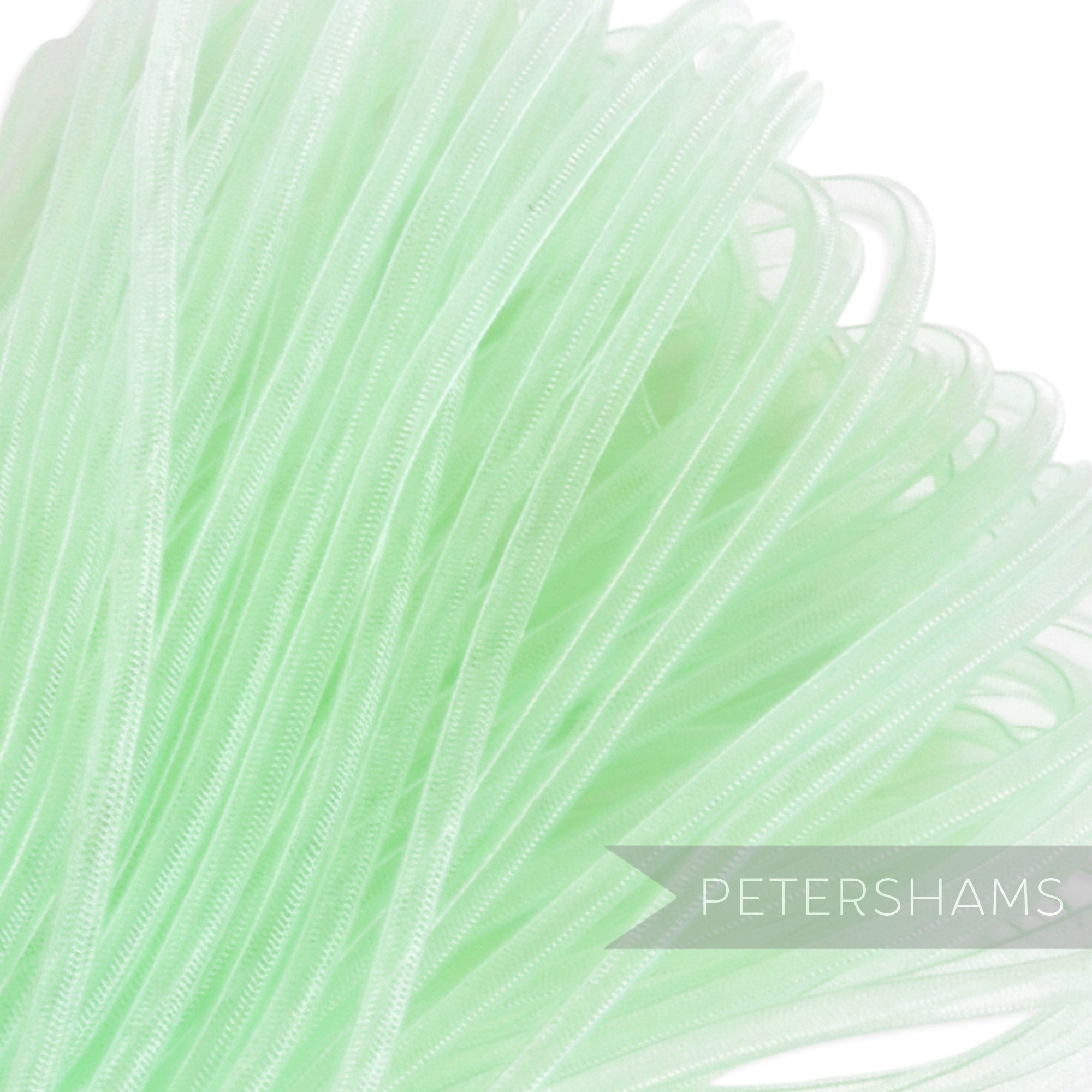 Petershams light green 4mm tube millinery crin, a sheer mesh trim with a gathered thread.
