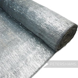 Petershams Millinery Supplies grey lurex threaded polyester abaca fabric with a rustic, slightly sheer finish and wavy threading.