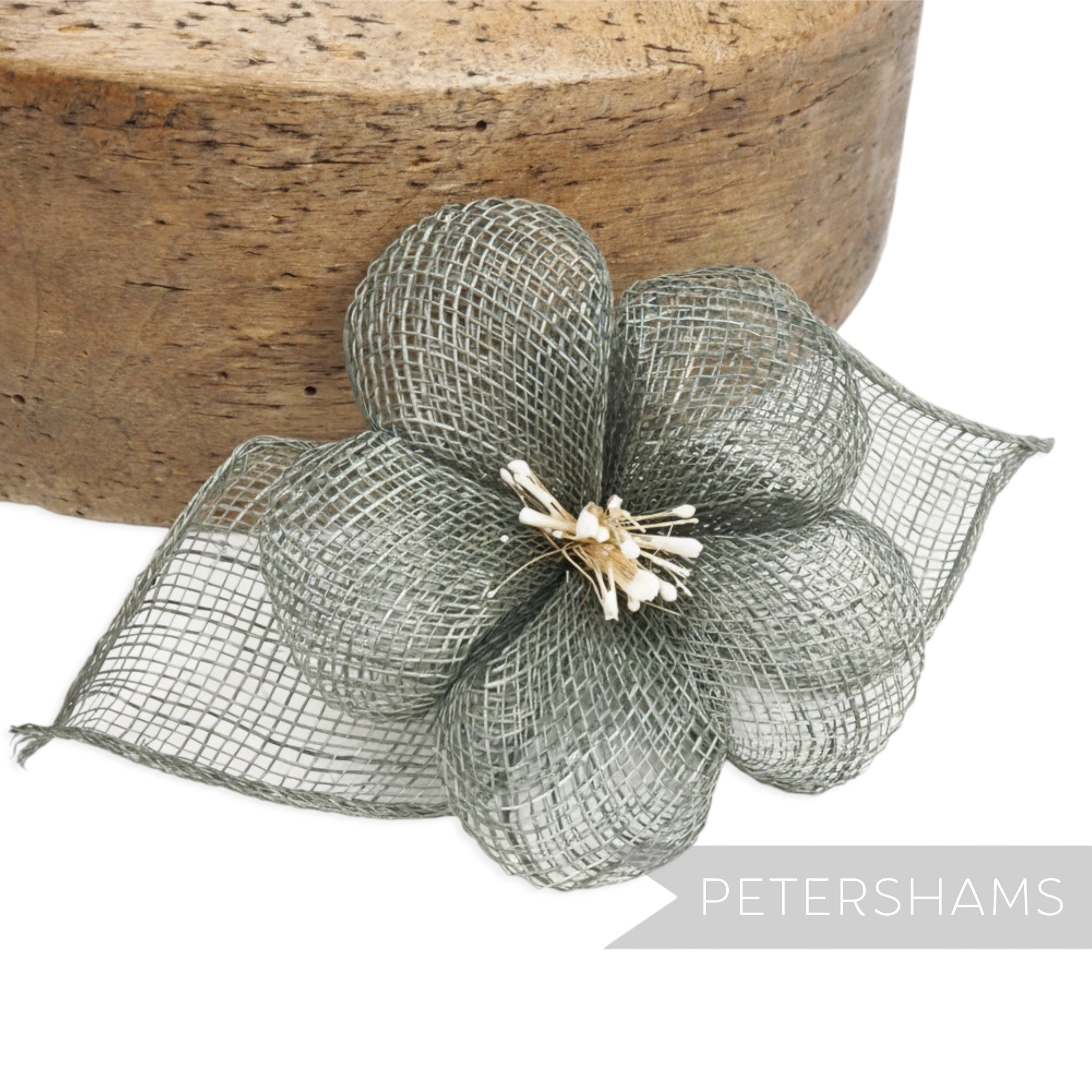 Petershams Millinery Supplies grey sinamay hibiscus flower hat mount with rolled leaves and stamens.