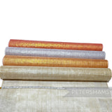 Petershams Millinery Supplies metallic lurex threaded sinamay fabric in orange, silver, gold, and beige. Ideal for hat making.