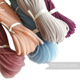 Petershams Millinery Supplies 4mm tube crin in peach, dusty rose, sky blue, pale grey, and plum. Slightly sheer, gathered trim.