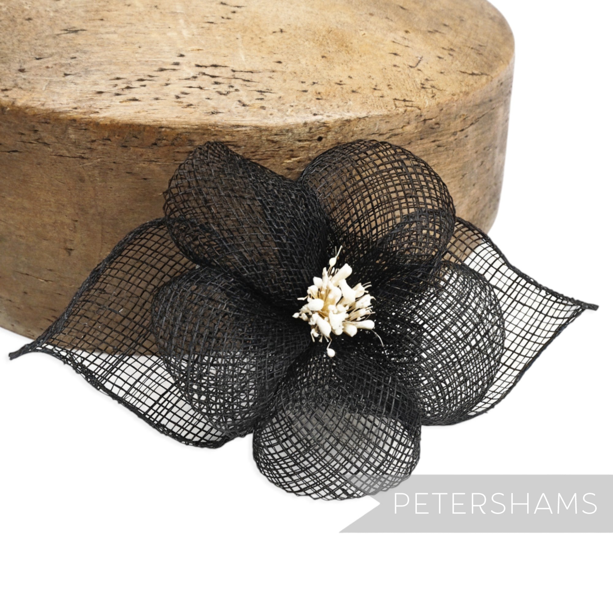 Petershams Millinery Supplies black sinamay hibiscus flower with rolled leaves and stamens, 15cm wide.