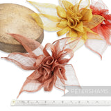 Petershams Millinery Supplies large layered sinamay flower hat mount in rust, gold, and red. Features rolled blossoms, leaves, and loops.
