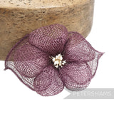 Petershams Millinery Supplies 'Sophie' hibiscus-style sinamay flower mount in plum with rolled sinamay leaves and stamens.