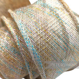 Petershams Millinery Supplies rainbow lurex sinamay ribbon with hand-rolled edges and metallic threads in blue, pink, and gold.