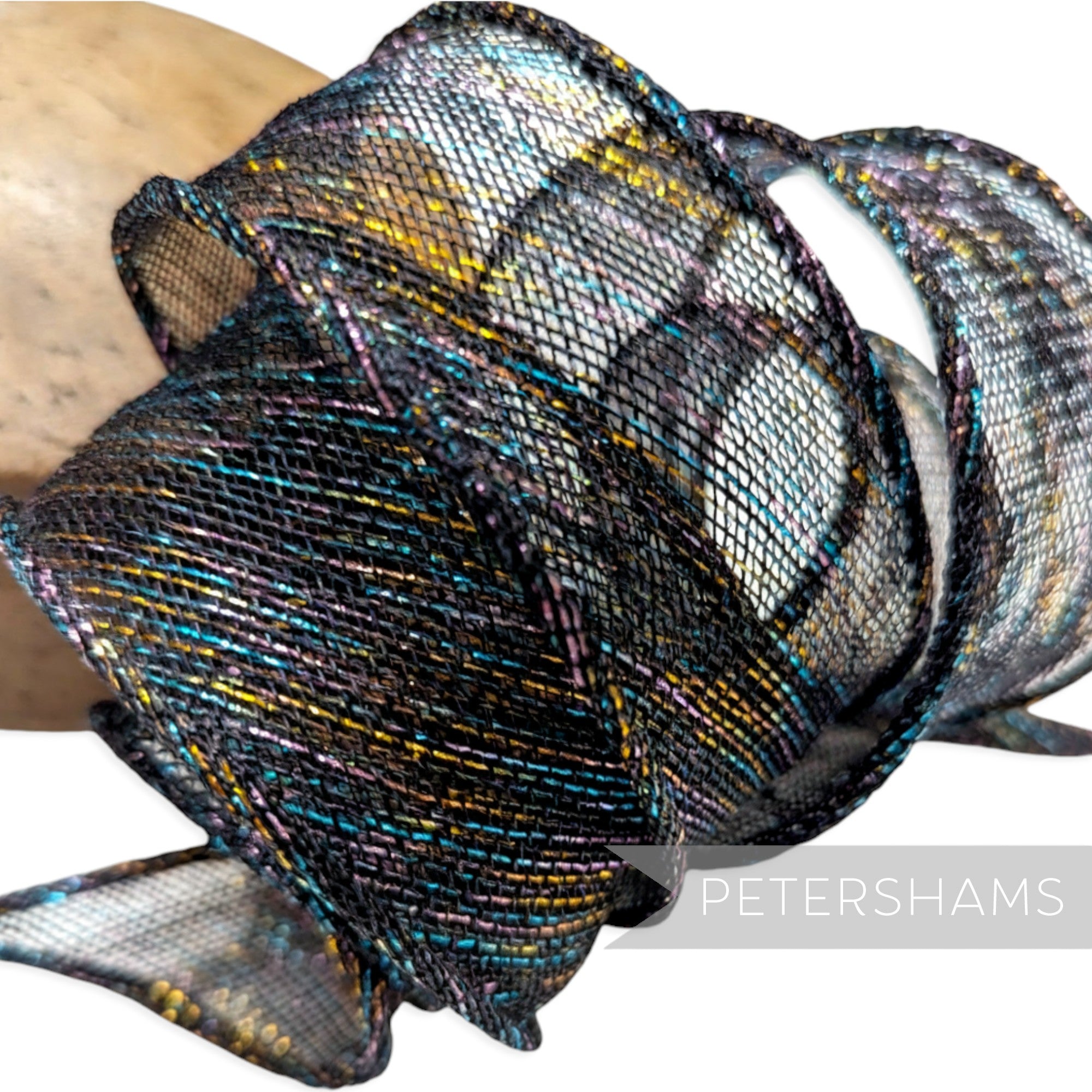Petershams Millinery Supplies black sinamay ribbon with rainbow lurex threads, hand-rolled edges, and tapered ends for hat trims.