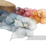 Petershams Millinery Supplies 'Sophie' hibiscus sinamay flower mount with leaves and stamens in blue, burgundy, pink, and orange.