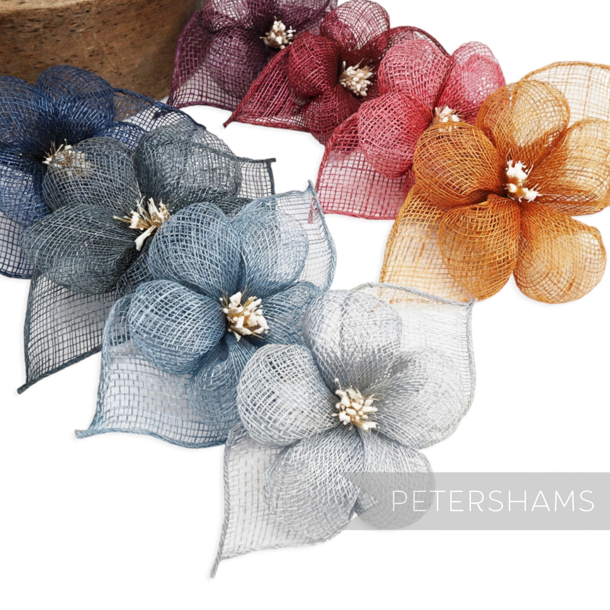 Petershams Millinery Supplies hibiscus sinamay flower mount with leaves and stamens in navy, grey, blue, burgundy, red, and orange.