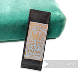 Petershams Millinery Supplies antique Kirby Beard egg eyed sewing needles in a black paper packet with gold label