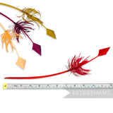 Petershams Millinery Supplies barbed arrowhead turkey quill feathers in red, yellow, and burgundy for headpieces.